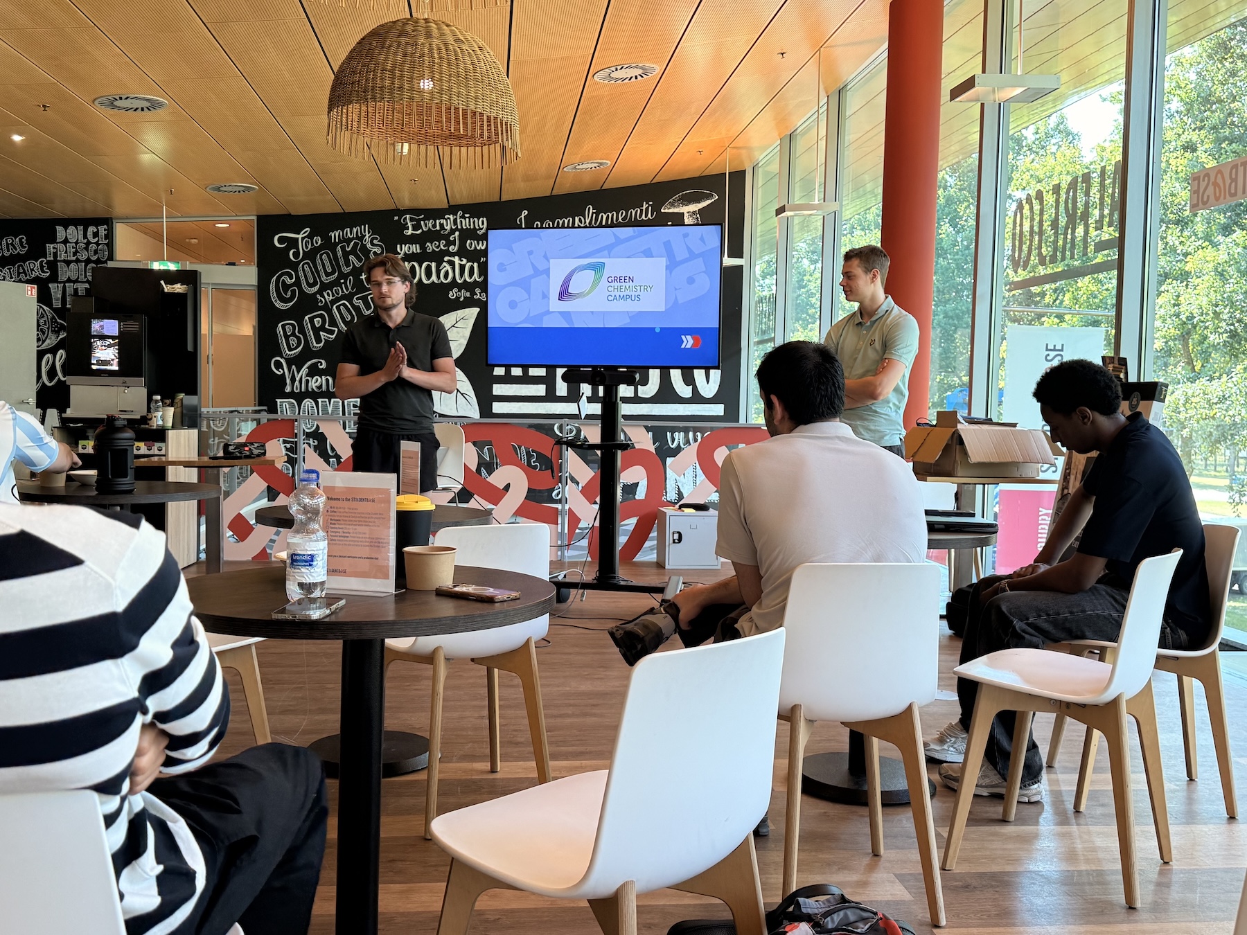 Two students presenting in front of a screen